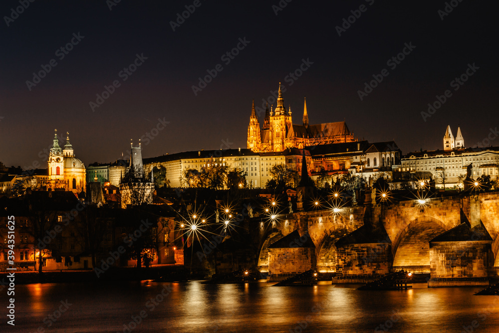 Postcard view of night Prague panorama, capital of the Czech republic.Amazing European cityscape.Prague Castle,Charles Bridge,Vltava river at colorful sunset.Famous tourist destination.Night city.