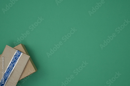 Gift boxes on a green background. Christmas and New Year's decor. Copy space, mock up
