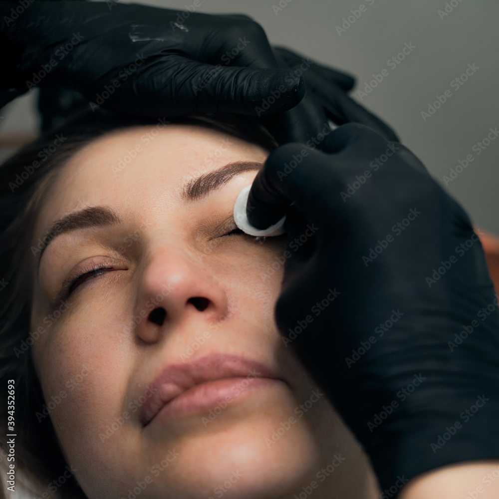Permanent eyebrow makeup procedure. Eyebrow tattooing, process. The use of tools by a master for permanent eyebrow makeup. Permanent eyebrow makeup procedure. Eyebrow tattooing, process. The use of tools by a master for permanent eyebrow makeup.