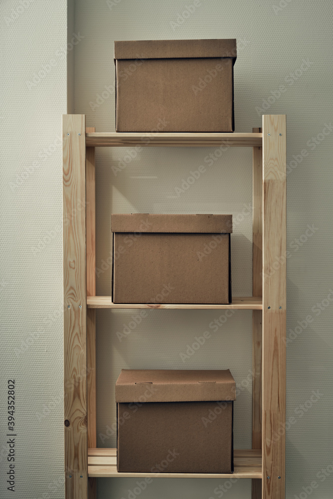 Paper boxes are on a wooden rack. Archive storage, use of eco-friendly materials Paper boxes are on a wooden rack. Archive storage, use of eco-friendly materials