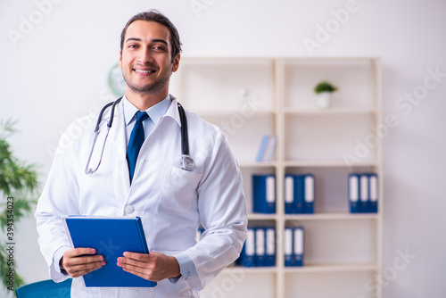 Young male handsome doctor working in the clinic