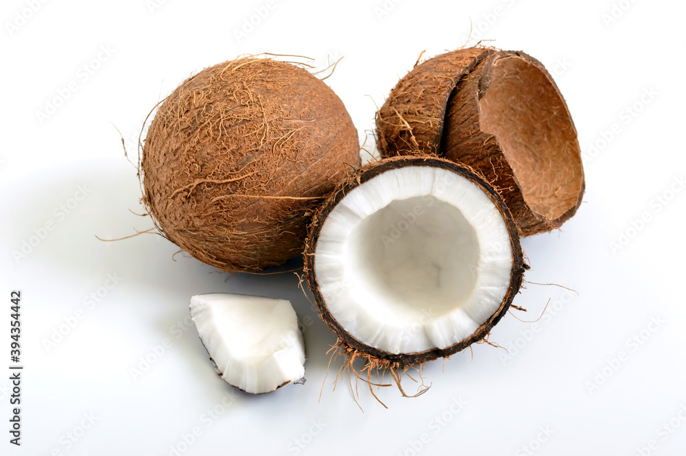 Coconut on a white background. Whole coconut, halves, shells, pieces of coconut.