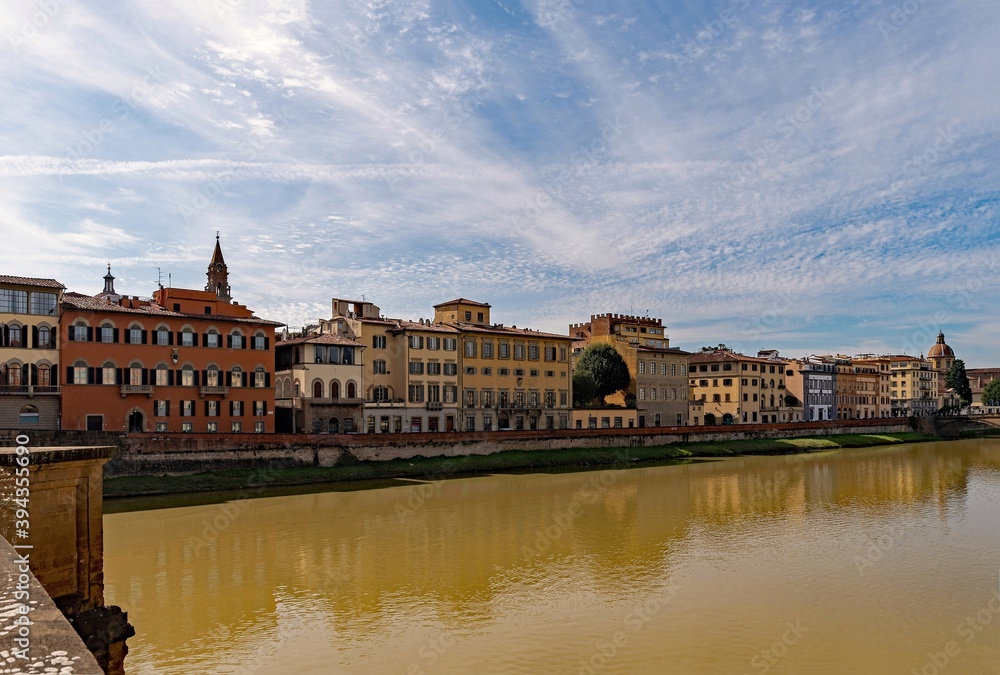 Row of houses reflecting in the Arno River at the old town of Florence, Tuscany Region in Italy 