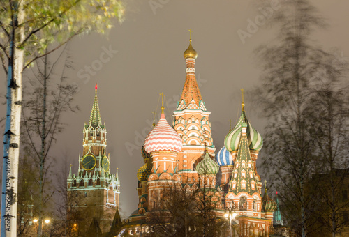 Moscow, Russia, Kremlin. St. Basil's catherdral and Spasskaya tower in night. View from Zaryadye park. Trees swaying in the wind