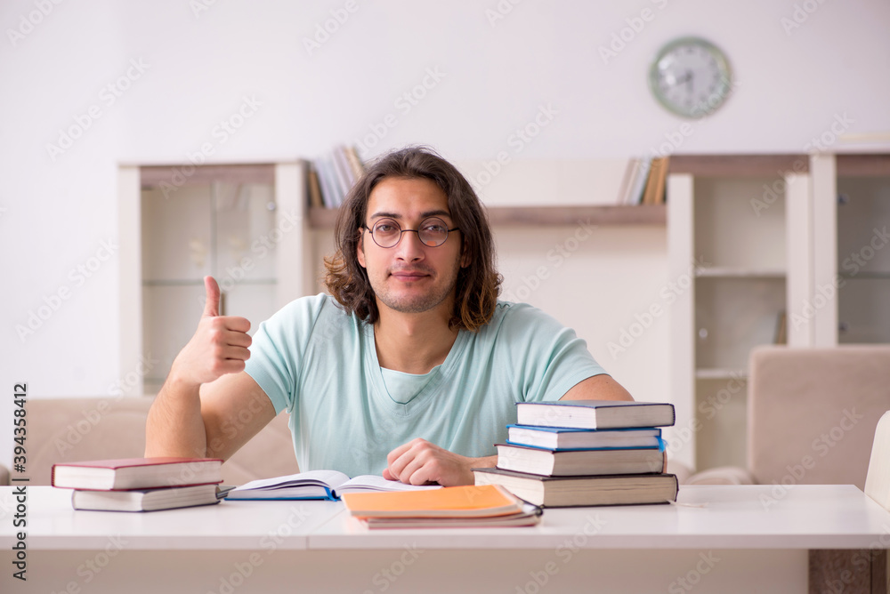 Young male student preparing for exams at home Young male student preparing for exams at home