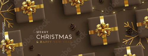 Christmas banner. Background Xmas design of realistic brown gifts box, golden 3d render snowflake and glitter light garlands, bauble ball. Horizontal poster, greeting card, headers for website