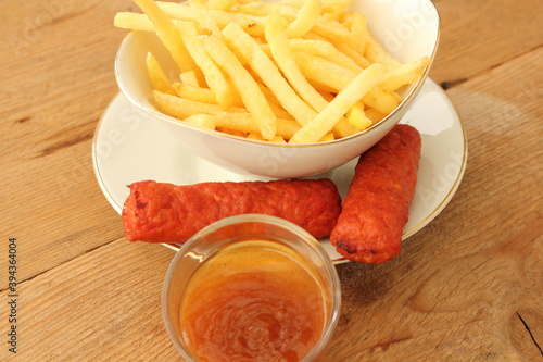 delicious french fries with cevapcici rolls and dip