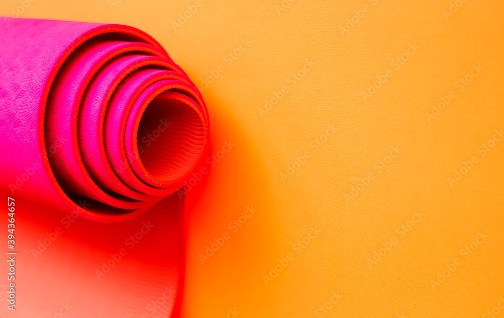 bright pink ultramarine yoga mat on a orange background bright pink ultramarine yoga mat on a orange background