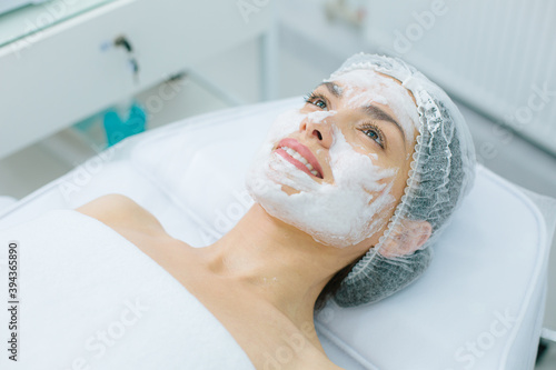 Happy woman feeling good during pleasant skin treatment