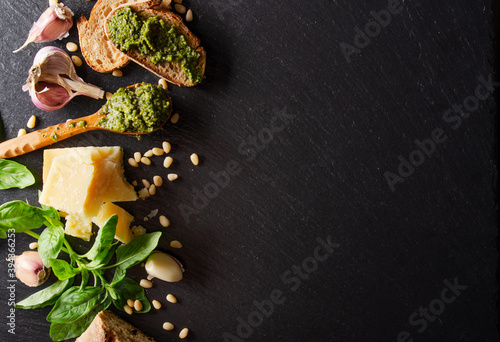 Flat lay view at food ingredients for pesto sauce on slate tray