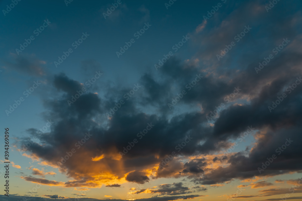 Obraz premium Dramatic sunset sky, orange and dark clouds.