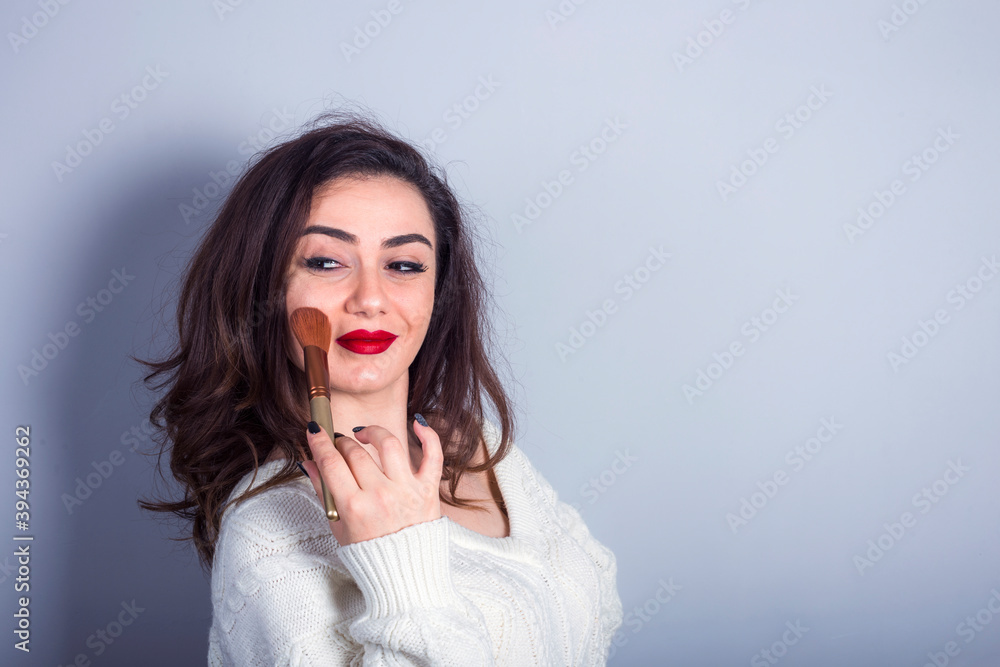 Model With Powder young model applying powder on her cheeks Stock Photo | Adobe Stock