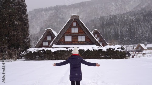 Young woman traveler enjoying with snow at shirakawa-go in winter