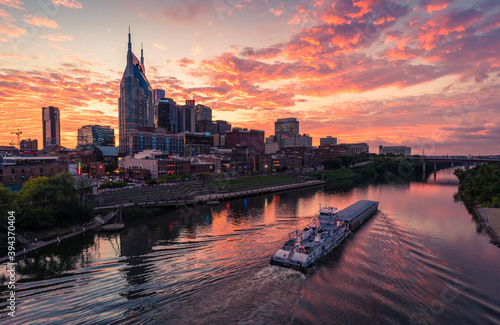 Epic Sunset Skyline in Nashville  Tennessee with a boat on the river
