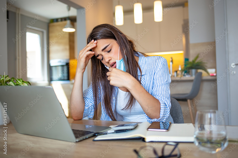 Woman with a protective face mask having breathing troubles. Business woman in mask sitting at desk feels unhealthy put hand where is lungs, suffering from repeated coughing and breath difficulties. Woman with a protective face mask having breathing troubles. Business woman in mask sitting at desk feels unhealthy put hand where is lungs, suffering from repeated coughing and breath difficulties.