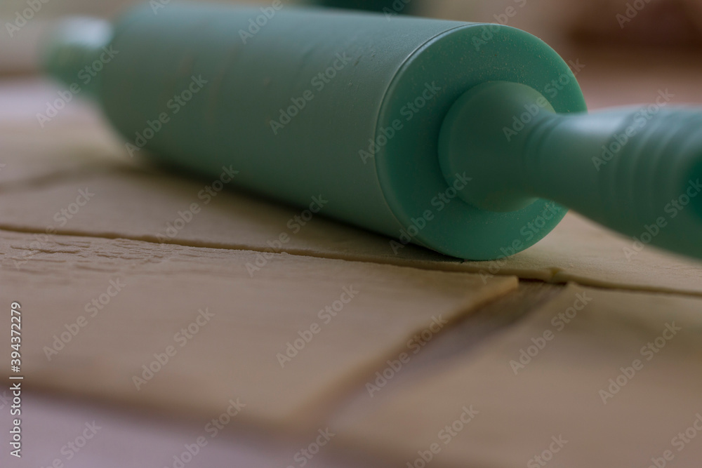 the rolling pin lies on the rolled and cut dough the rolling pin lies on the rolled and cut dough