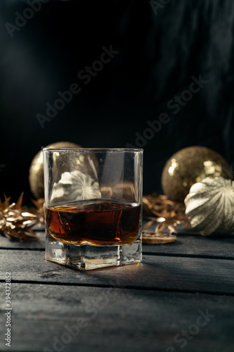 Glass of brandy on dark wooden desk