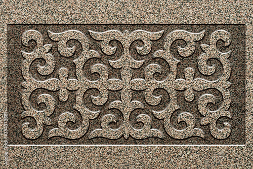 Ornamental print on the stone surface. Vintage ornament on the stone. Close-up seamless texture. Stone texture. Pattern on the stone. Embossed pattern. Wallpaper.