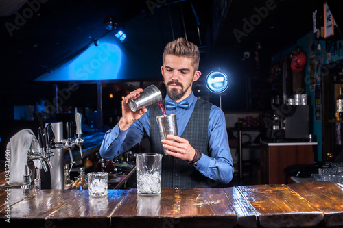 Bartender mixes a cocktail in the bar photo