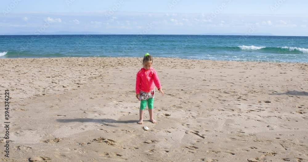 four years old girl looking for, picking and collecting sea shells at sand beach shore, next to mother or babysitter, in Bolonia Beach, Cadiz, Andalusia, Spain, Europe.
four years old girl looking for, picking and collecting sea shells at sand beach shore, next to mother or babysitter, in Bolonia Beach, Cadiz, Andalusia, Spain, Europe.