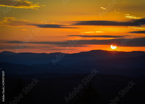 Orange sunset over wind turbine mountains Mount Olga Wilmington Vermont Nov. 2020