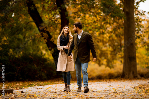 Young couple walking in the autumn park