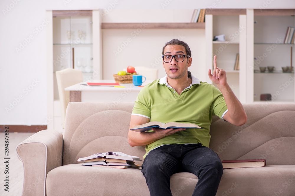 Young male student preparing for exams at home Young male student preparing for exams at home