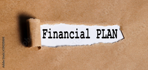 FINANCIAL PLAN, TEXT on white paper on torn paper background