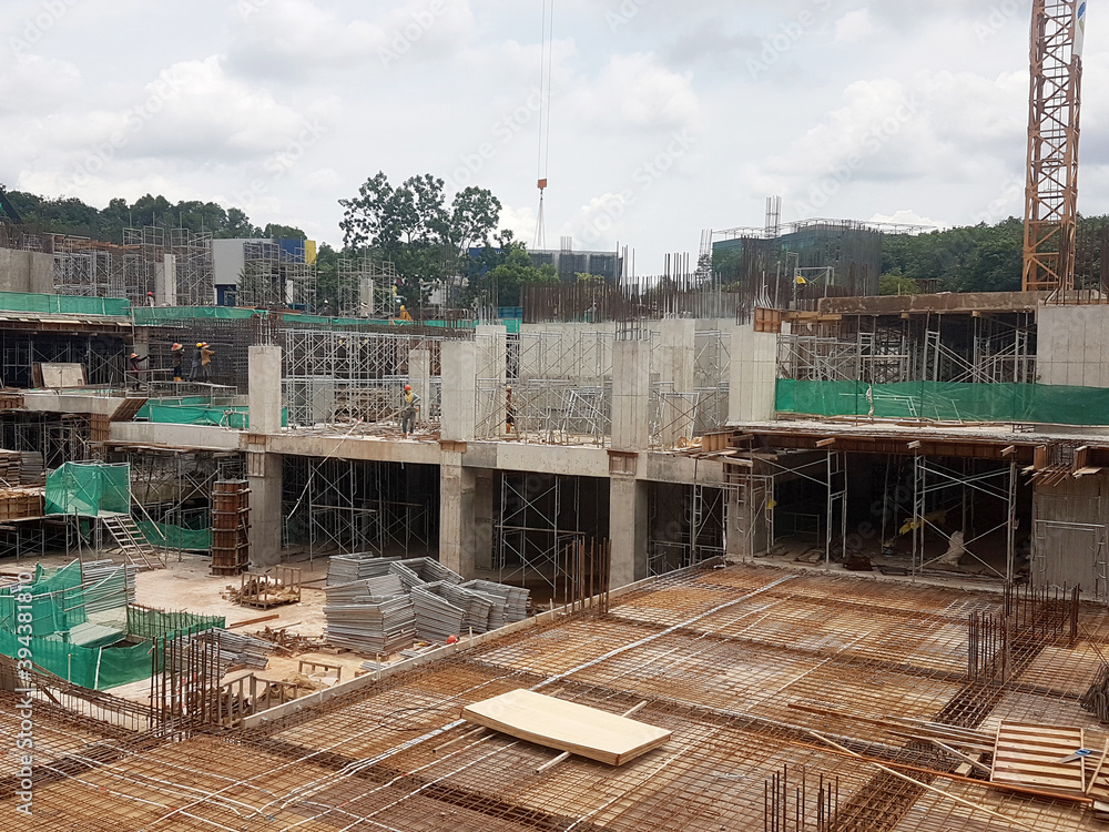 KUALA LUMPUR, MALAYSIA -NOVEMBER 21, 2020: Building floor slab under construction. Construction workers fabricating the timber formwork and installing the steel reinforcement bar. 