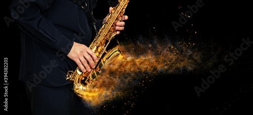 Fotografie, Obraz Saxophone with disperse dust effect Player hands Saxophonist playing jazz music