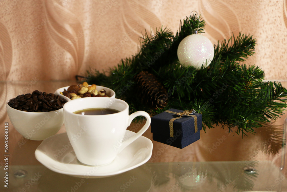 A cup of coffee on the table against the background of New Year's decor. Cup of coffee with Christmas decor on the table. A cup of coffee on the table against the background of New Year's decor. Cup of coffee with Christmas decor on the table.