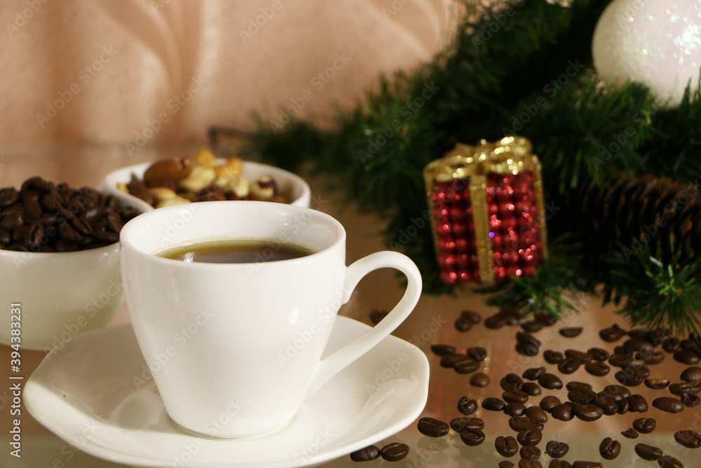 A cup of coffee on the table against the background of New Year's decor. Cup of coffee with Christmas decor on the table. A cup of coffee on the table against the background of New Year's decor. Cup of coffee with Christmas decor on the table.
