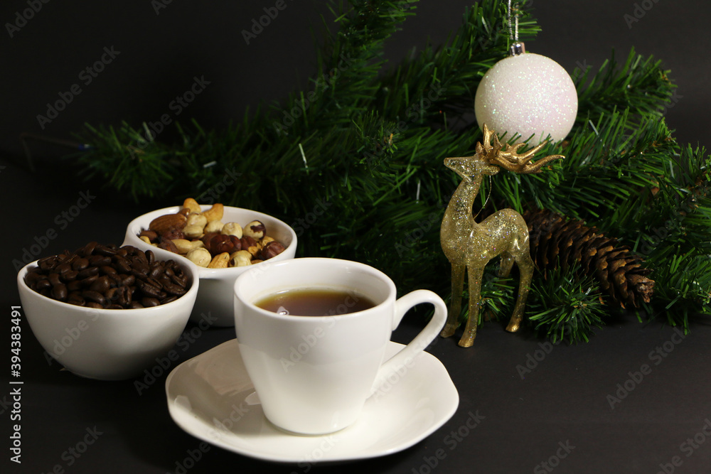 A cup of coffee on the table against the background of New Year's decor. Cup of coffee with Christmas decor on the table. A cup of coffee on the table against the background of New Year's decor. Cup of coffee with Christmas decor on the table.