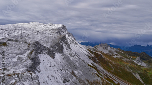Beautiful panoramic view of the snow-capped rugged R  tikon mountains near Gargellen in Montafon  Alps at the border of Austria and Switzerland on a cloudy day in autumn season.