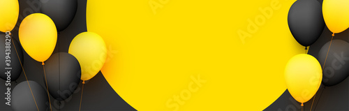 Black and yellow balloons with threads on yellow background.