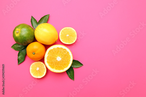 Beautiful lemon, orange, tangerine on pink background