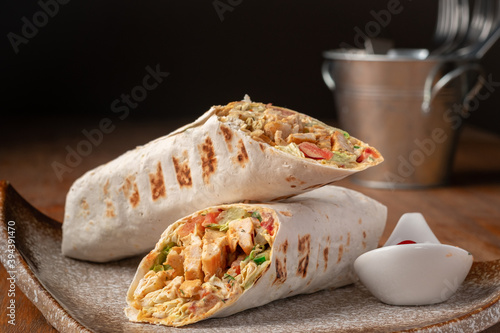 Chicken Doner-kebab or roll with chicken and mustard sauce on a plate photo