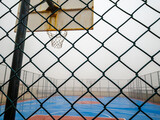 basketball coart and green wire netting with hoop. outdoor sport theme
