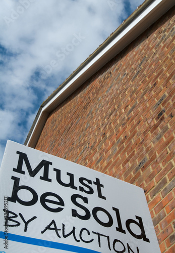A board outside a residential property, which is for sale by auction.