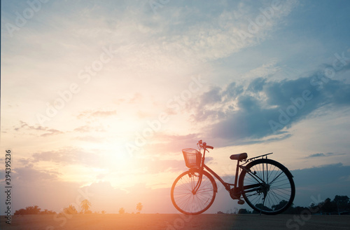 silhouette of bicycle with beautiful cloudscape and sunlight.