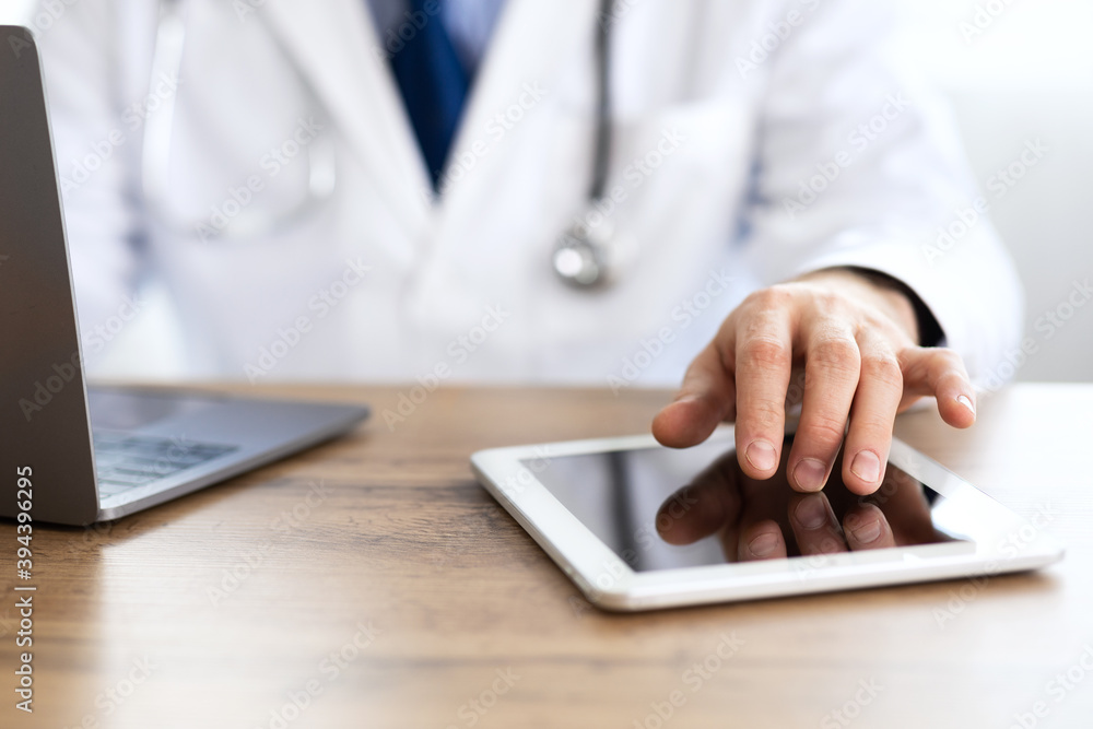 Close up of medical practitioner using his digital tablet Close up of medical practitioner using his digital tablet