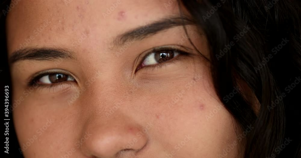 Casual hispanic woman eyes sight in suspicion Casual hispanic woman eyes sight in suspicion