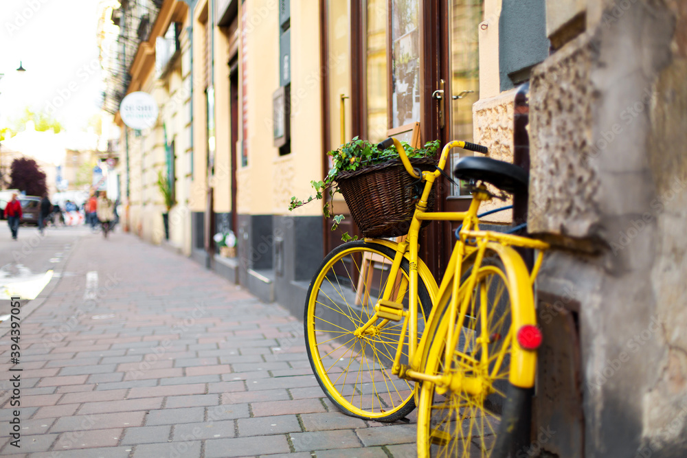 Cityscape of the old cozy European city. A flower pot from an old bicycle Cityscape of the old cozy European city. A flower pot from an old bicycle