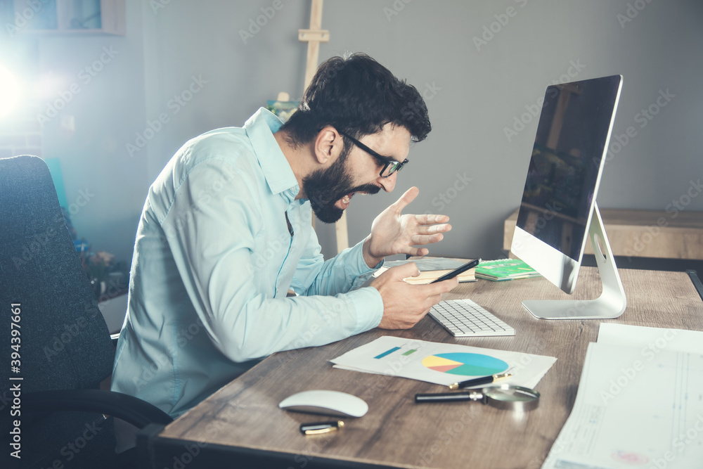 Angry businessman working in the office Angry businessman working in the office