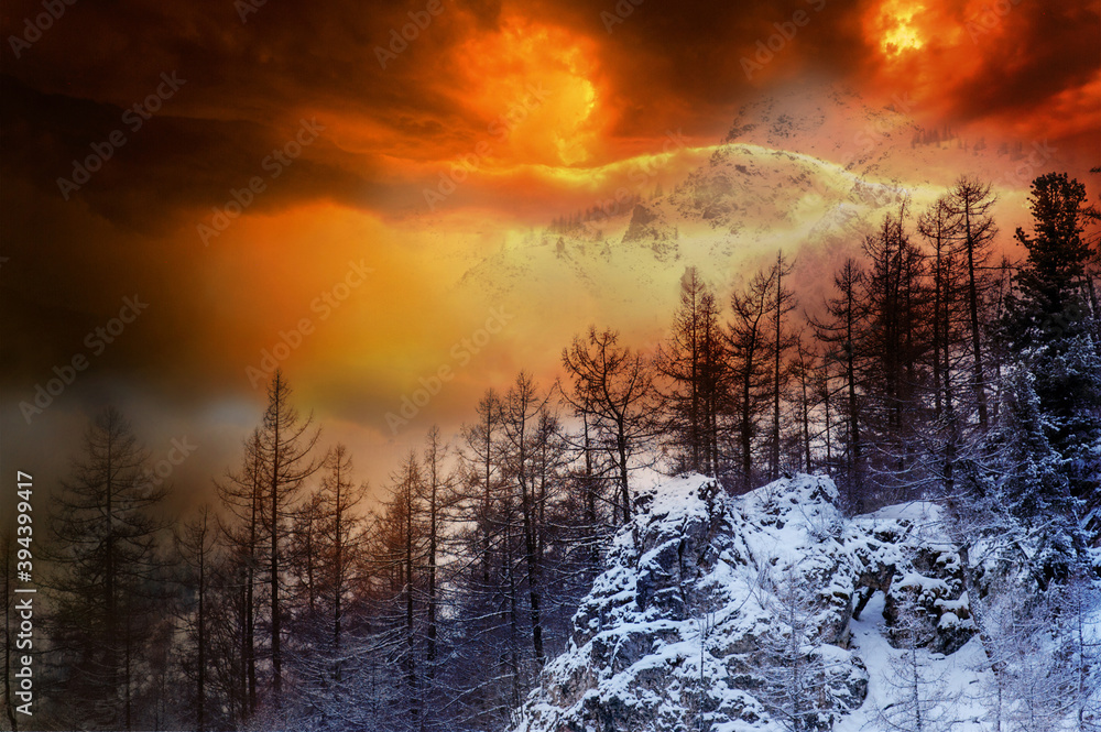 Colorful fire storm dramatic sky in the snow mountain. Mountain landscape. Dramatic sunset sky over mounts.