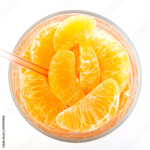 real natural orange juice with sliced in a glass. White background isolated.