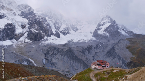 Beautiful panorama view of the eastern side of Ortler massif with glacier Suldenferner and mountain shelter Schaubachhütte on a cloudy day in fall season near Sulden in South Tyrol, Italy in the Alps. photo