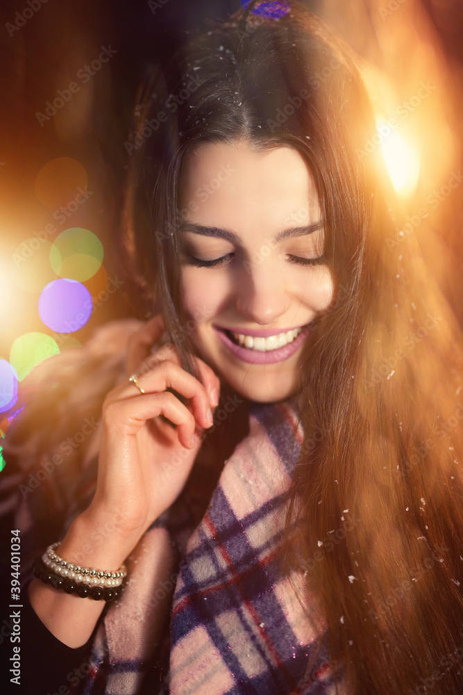 portrait of a young girl smiling on a cold winter evening
