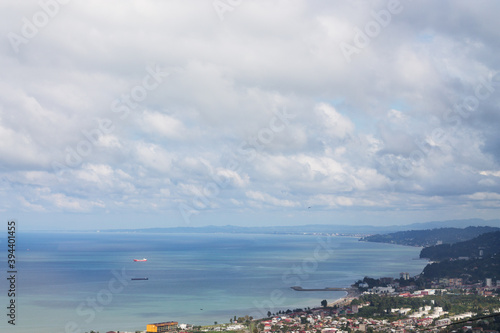 Beautiful blue sea coast of Batumi against the background of white Cirrus clouds. © photography