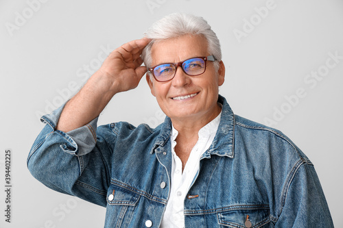 Stylish senior man on grey ...